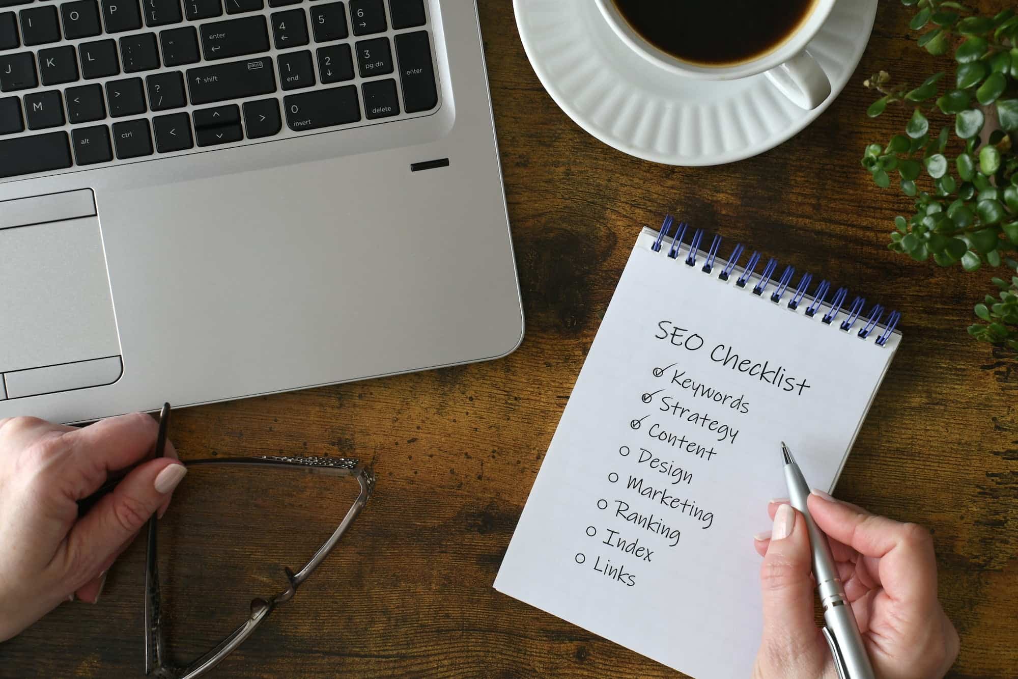 Female checking off items on SEO checklist - seo company in west palm beach