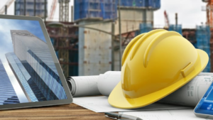 a tablet and a yellow safety helmet on a table at a construction area symbolizing the SEO services for construction companies